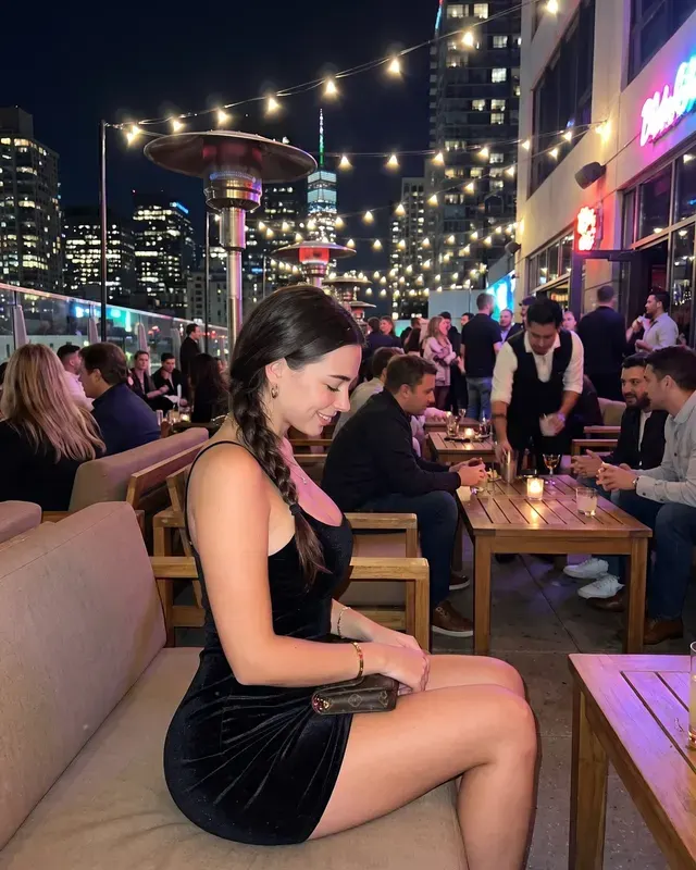 Night Out / City Rooftop AI photoshoot sample 1 of 5: natural candid Instagram-style photo of the same woman, different outfit and pose