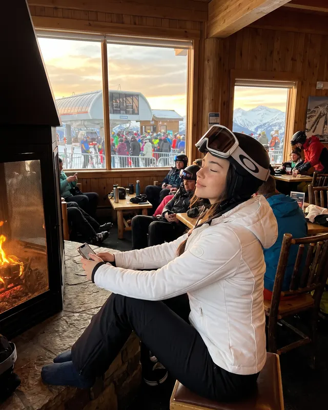 Mountain / Ski Cabin AI photoshoot sample 4 of 5: natural candid Instagram-style photo of the same woman, different outfit and pose