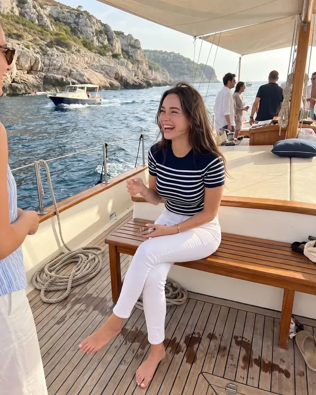 Yacht Life AI photoshoot sample 1 of 5: natural candid Instagram-style photo of the same woman, different outfit and pose
